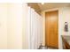 Bathroom with white shower curtain, wooden door, and granite vanity at 150 Bee St # 713, Charleston, SC 29401