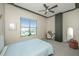 This cozy bedroom is brightly lit with large windows and features a ceiling fan at 150 Bee St # 713, Charleston, SC 29401