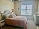 Bedroom featuring a neutral color scheme, natural light, and wooden furniture at 150 Bee St # 713, Charleston, SC 29401