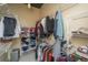 Walk in closet with shelves on either side and clothing hanging on racks at 150 Bee St # 713, Charleston, SC 29401