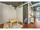 Dining area with modern wood table and high ceilings, leading to balcony at 150 Bee St # 713, Charleston, SC 29401
