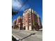 A brick building with many stories and balconies sits under a bright blue sky at 150 Bee St # 713, Charleston, SC 29401