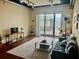Bright living room with sliding glass doors and modern decor and hardwood flooring at 150 Bee St # 713, Charleston, SC 29401
