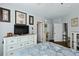 Coastal bedroom featuring a white dresser with a TV and artwork, creating a serene, beach-inspired atmosphere at 1522 Telfair Way, Charleston, SC 29412