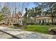 Stunning exterior view of a plantation-style home with a red roof, manicured landscaping, and classic architectural design at 1522 Telfair Way, Charleston, SC 29412
