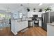Bright kitchen featuring stainless steel appliances, granite countertops, and hardwood floors at 1522 Telfair Way, Charleston, SC 29412
