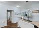 Well-lit kitchen area open to the living area with wood-style flooring at 1522 Telfair Way, Charleston, SC 29412
