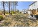 Lush backyard view showcasing mature trees and neighboring homes, creating a serene and private outdoor space at 1704 Tolbert Way, Mount Pleasant, SC 29466