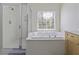 Bright bathroom features a stand-up shower, luxurious soaking tub, and a bright window with wooded views at 1704 Tolbert Way, Mount Pleasant, SC 29466