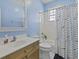 Bright bathroom featuring a vanity, toilet, shower/tub combo, and window for natural lighting at 1704 Tolbert Way, Mount Pleasant, SC 29466