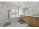 This spacious bathroom has a stand-up shower, large tub, double sink vanity, and a bright window at 1704 Tolbert Way, Mount Pleasant, SC 29466