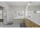This bathroom features a walk-in shower, soaking tub, and a wooden double sink vanity with quartz countertops at 1704 Tolbert Way, Mount Pleasant, SC 29466