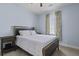 Comfortable bedroom features a queen-size bed, side table, neutral carpeting, and natural lighting at 1704 Tolbert Way, Mount Pleasant, SC 29466