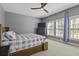 Inviting bedroom with a plaid bedspread, tv, and windows with curtains for a blend of comfort and style at 1704 Tolbert Way, Mount Pleasant, SC 29466