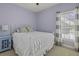 Charming bedroom features a white metal bed frame, carpeting, and a window providing natural light at 1704 Tolbert Way, Mount Pleasant, SC 29466