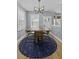 Bright dining room with stylish lighting fixture, table set and round rug at 1704 Tolbert Way, Mount Pleasant, SC 29466