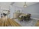 Elegant dining room featuring hardwood floors, stylish lighting, and comfortable seating for six at 1704 Tolbert Way, Mount Pleasant, SC 29466