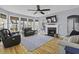 A comfortable living room featuring a fireplace, built-ins, and bay windows at 1704 Tolbert Way, Mount Pleasant, SC 29466