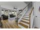 Bright living room adjacent to the staircase features a fireplace and bay windows at 1704 Tolbert Way, Mount Pleasant, SC 29466