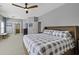 This main bedroom features an ensuite, ceiling fan, and calming neutral colors throughout at 1704 Tolbert Way, Mount Pleasant, SC 29466