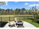 Serene backyard with a fire pit, seating area, and a scenic pond view at 1772 Agate Bay Dr, Mount Pleasant, SC 29466
