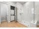 Modern bathroom with a glass walk-in shower and a stacked washer and dryer unit in closet at 1772 Agate Bay Dr, Mount Pleasant, SC 29466