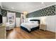 Cozy bedroom with wallpapered accent wall, white wainscoting, and bright windows at 1772 Agate Bay Dr, Mount Pleasant, SC 29466