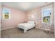 Charming bedroom with floral wallpaper, bright windows, and a cozy rocking chair at 1772 Agate Bay Dr, Mount Pleasant, SC 29466