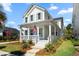 Charming two-story home featuring a welcoming front porch with an American flag and delightful landscaping at 1772 Agate Bay Dr, Mount Pleasant, SC 29466