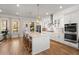 Bright kitchen featuring a large island with seating, stainless steel appliances, and white cabinets at 1772 Agate Bay Dr, Mount Pleasant, SC 29466