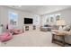 Bright living room features large sectional sofa, TV, and a wall of windows at 1772 Agate Bay Dr, Mount Pleasant, SC 29466