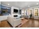 Well-lit living room with a modern fireplace, built-in shelves, and large windows showcasing the outdoor views at 1772 Agate Bay Dr, Mount Pleasant, SC 29466
