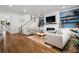 Spacious living room with hardwood floors, comfortable seating, a modern fireplace, and staircase at 1772 Agate Bay Dr, Mount Pleasant, SC 29466