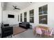 Inviting outdoor porch with comfortable seating, mounted TV, ceiling fan, and table for entertainment at 1772 Agate Bay Dr, Mount Pleasant, SC 29466