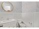 Chic powder room with stylish wallpaper, wainscoting, and gold framed mirror at 1772 Agate Bay Dr, Mount Pleasant, SC 29466
