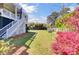 Lush backyard featuring a spacious lawn, mature trees, and flourishing bushes at 185 5Th Ave, Mount Pleasant, SC 29464