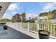 Wide balcony with white railings and scenic views of mature trees at 185 5Th Ave, Mount Pleasant, SC 29464