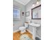 Powder room featuring a pedestal sink, toilet, and window with blinds at 185 5Th Ave, Mount Pleasant, SC 29464