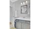 Well-lit bathroom featuring grey vanity, white counter, and updated fixtures at 185 5Th Ave, Mount Pleasant, SC 29464