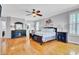 Bright primary bedroom features hardwood floors, ceiling fan, and large windows at 185 5Th Ave, Mount Pleasant, SC 29464