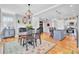 Open-concept dining area connecting to the kitchen, featuring hardwood floors and natural light at 185 5Th Ave, Mount Pleasant, SC 29464