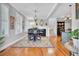Elegant dining area with a fireplace, hardwood floors, and stylish lighting at 185 5Th Ave, Mount Pleasant, SC 29464