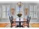 Charming dining room with natural light, vintage-style decor, hardwood floors and a stylish chandelier at 185 5Th Ave, Mount Pleasant, SC 29464