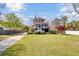 Beautiful exterior of a two-story home with mature trees, a large lawn, and a long driveway at 185 5Th Ave, Mount Pleasant, SC 29464