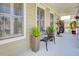 Relaxing covered front porch with comfortable seating and potted plants, creating a welcoming atmosphere at 185 5Th Ave, Mount Pleasant, SC 29464