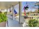 Inviting front porch with views and patriotic decor, perfect for enjoying the outdoors at 185 5Th Ave, Mount Pleasant, SC 29464