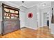 Hallway with a wooden hutch and view of the bathroom and front door at 185 5Th Ave, Mount Pleasant, SC 29464