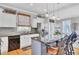 Bright kitchen features a central island with bar seating, stainless steel appliances, and modern fixtures at 185 5Th Ave, Mount Pleasant, SC 29464