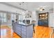 Open floor plan combining kitchen with center island, and dining space, with wood floors at 185 5Th Ave, Mount Pleasant, SC 29464