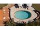 Overhead shot of oval backyard pool featuring sun umbrellas, lounge seating, and manicured grounds at 2014 Ion Ave, Sullivans Island, SC 29482